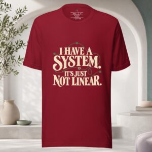 Cardinal red I Have a System It's Just Not Linear T-shirt with vintage cream typography and an abstract olive green winding line, All Minds Club.